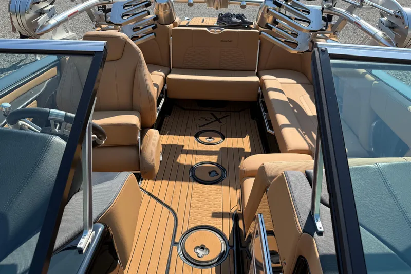 Slide: The Image of 2020 MasterCraft X22 boat interior with tan leather seating and sleek design. - 11