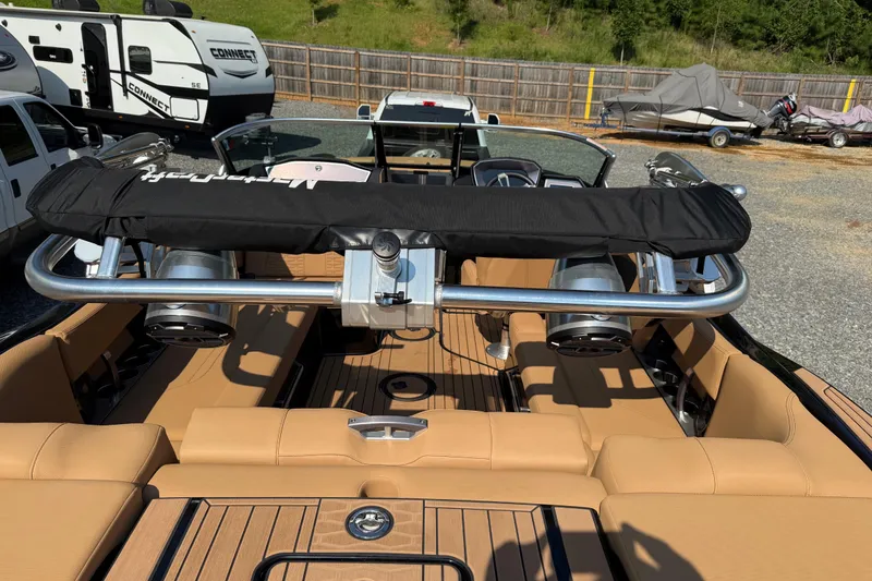 Slide: The Image of 2020 MasterCraft X22 boat interior with tan seating and wakeboard tower. - 13