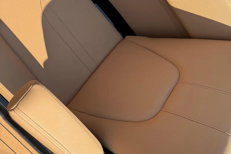 Slide: The Image of 2020 MasterCraft X22 boat seat with tan upholstery, close-up view. - 15