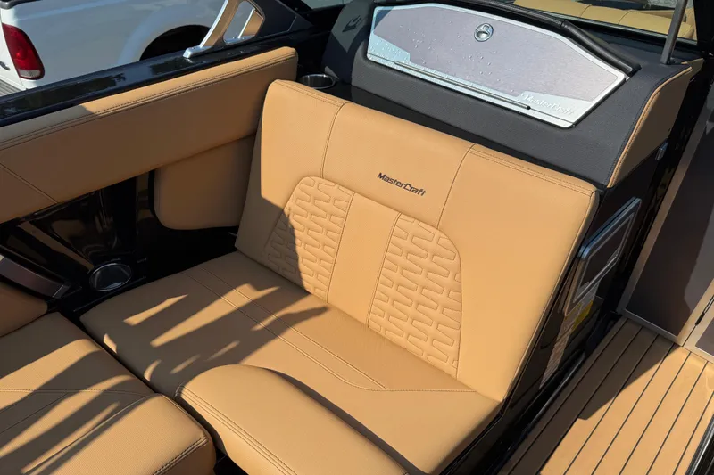 Slide: The Image of 2020 MasterCraft X22 boat interior with tan leather seating and sleek design. - 16