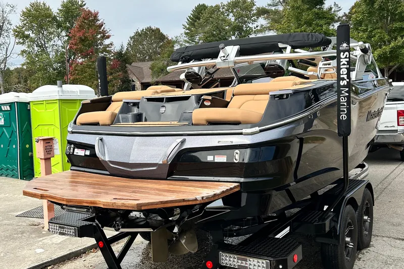 Slide: The Image of 2020 MasterCraft X22 boat on trailer, featuring sleek design and tan seating. - 7