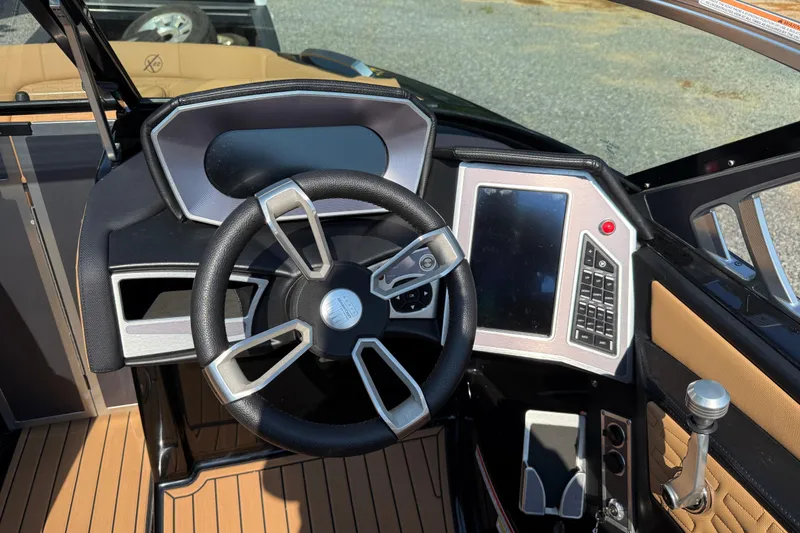 Slide: The Image of 2020 MasterCraft X22 boat dashboard with steering wheel and control panel. - 9