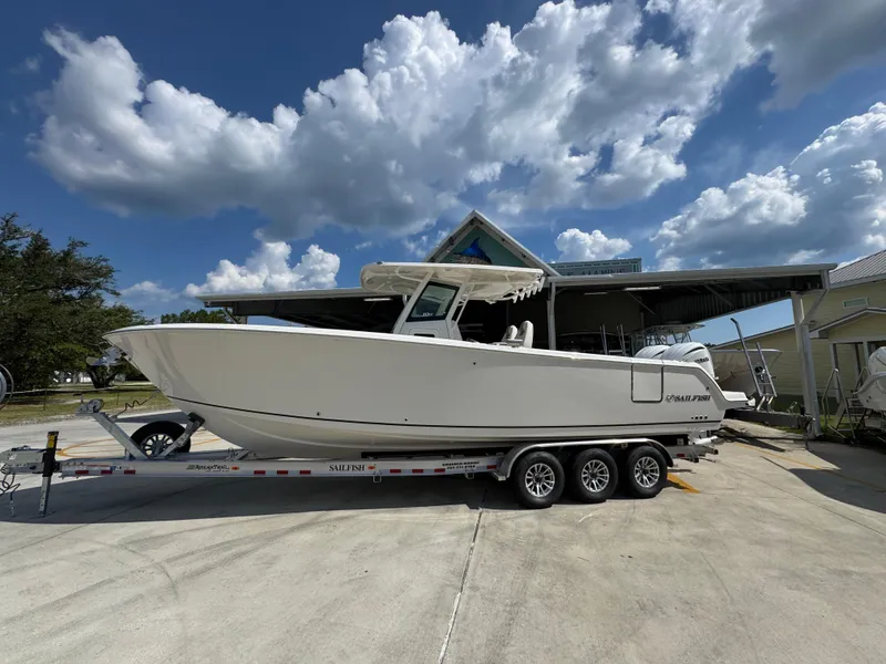 The Image of 2025 Sailfish 312 CC boat on trailer under cloudy sky. - 1