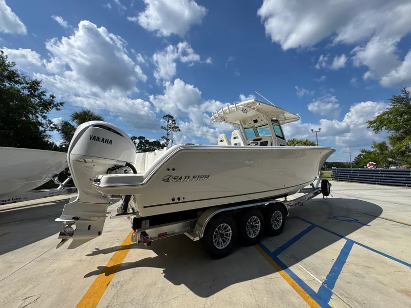 Slide: The Image of 2025 Sailfish 312 CC boat on trailer under a blue sky with clouds. - 16