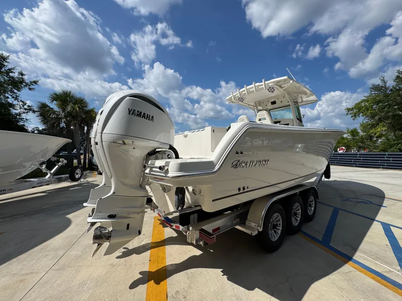 Slide: The Image of 2025 Sailfish 312 CC boat with Yamaha engine on trailer under blue sky. - 17