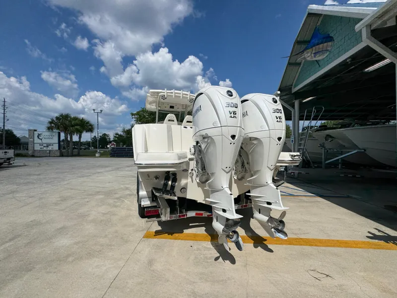 Slide: The Image of 2025 Sailfish 312 CC boat with dual Yamaha 300 V6 engines in a marina setting. - 21