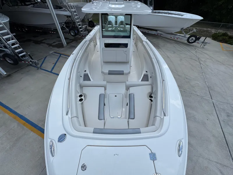 Slide: The Image of 2025 Sailfish 312 CC boat interior with seating, docked outdoors. - 28