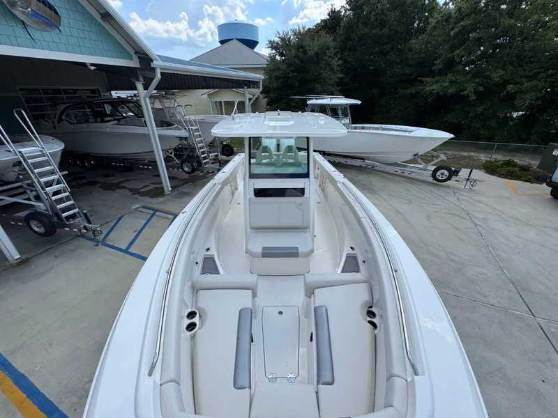 Slide: The Image of 2025 Sailfish 312 CC boat displayed at a dealership with other boats. - 29