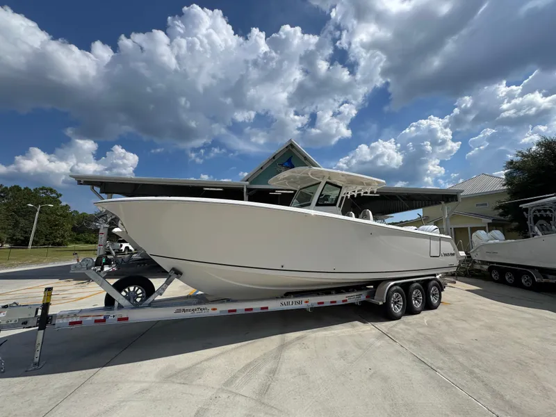Slide: The Image of 2025 Sailfish 312 CC boat on trailer under cloudy sky. - 3
