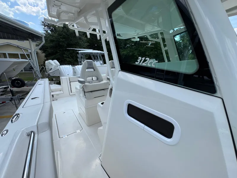 Slide: The Image of 2025 Sailfish 312 CC boat interior with seating and console, showcasing modern design. - 32
