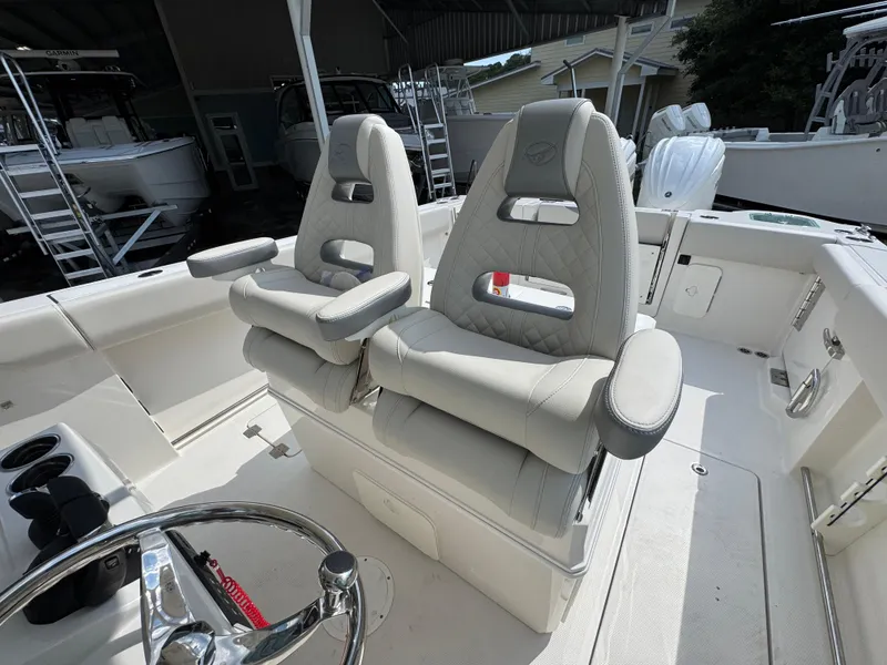 Slide: The Image of 2025 Sailfish 312 CC boat interior with luxurious seating and steering wheel. - 35