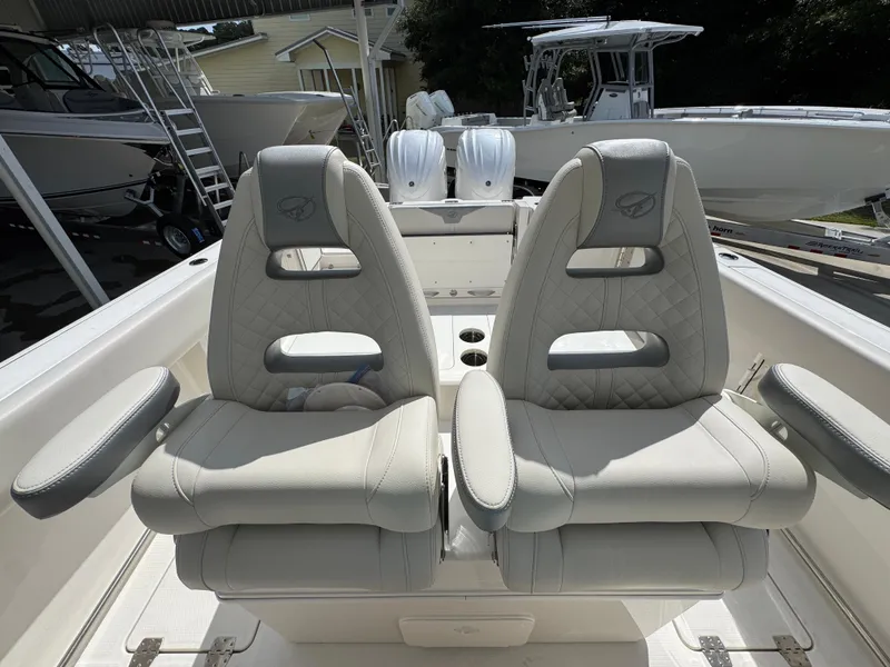 Slide: The Image of 2025 Sailfish 312 CC boat interior with two luxurious, cushioned seats and armrests. - 36