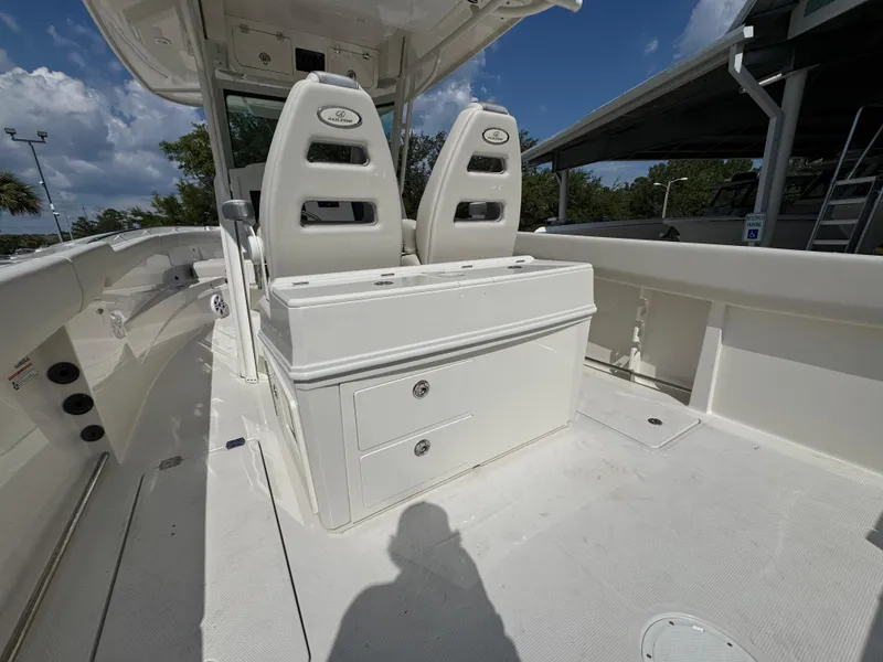 Slide: The Image of 2025 Sailfish 312 CC boat interior with dual seats and storage drawers. - 40