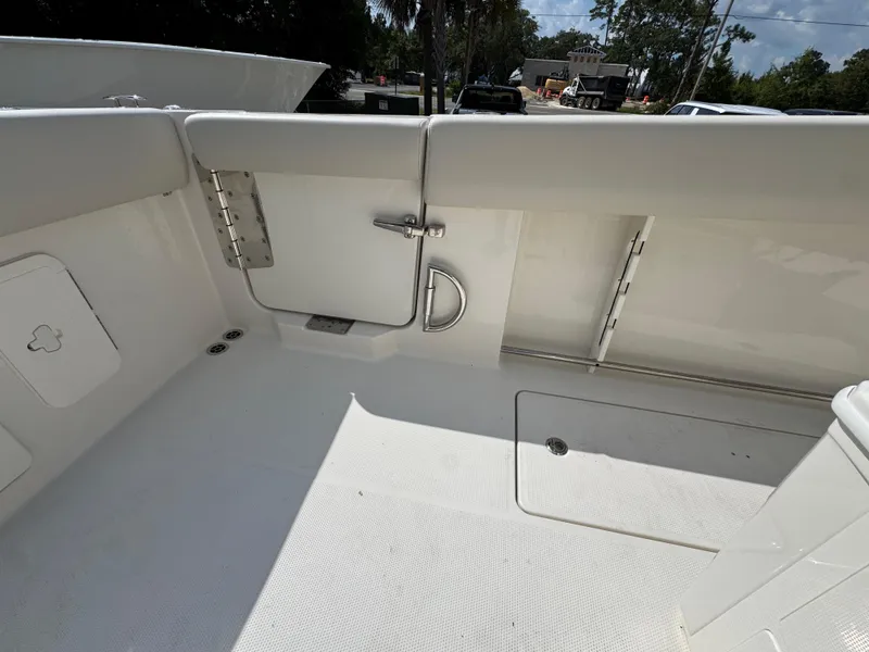 Slide: The Image of 2025 Sailfish 312 CC boat interior, featuring a clean, white deck and storage compartments. - 42