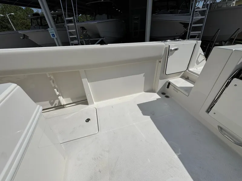 Slide: The Image of 2025 Sailfish 312 CC boat interior, featuring spacious deck and storage compartments. - 43