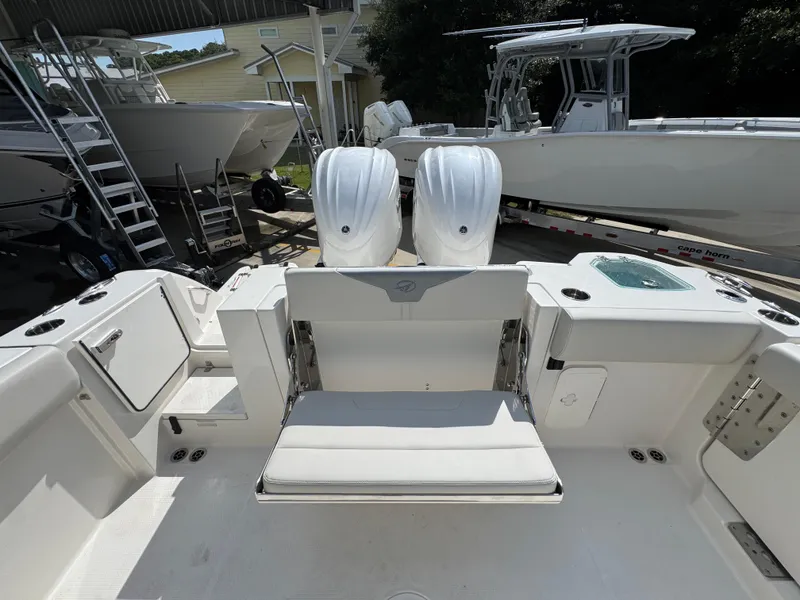 Slide: The Image of 2025 Sailfish 312 CC boat interior with dual engines and seating area. - 46