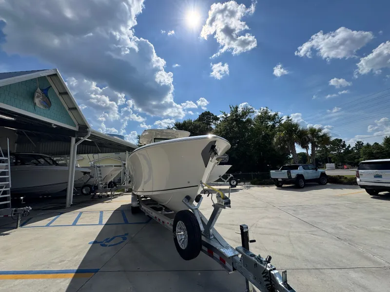 Slide: The Image of 2025 Sailfish 312 CC boat on trailer under sunny sky at marina. - 9