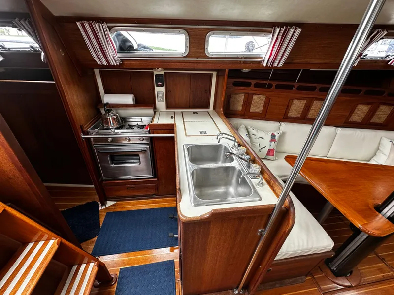 Slide: The Image of Interior of 1987 Ericson 34 2 sailboat with kitchen and seating area. - 13