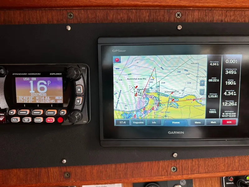 Slide: The Image of Navigation equipment on a 1987 Ericson 34 2 sailboat, featuring GPS and radio displays. - 16
