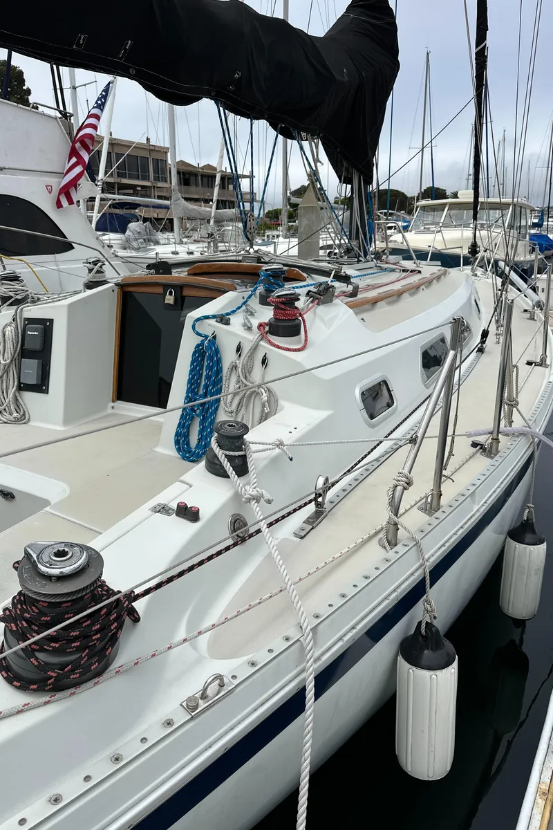 Slide: The Image of 1987 Ericson 34 2 sailboat docked, featuring deck details and rigging. - 2