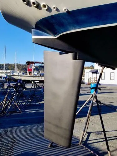 Slide: The Image of 1987 Ericson 34 2 sailboat keel on display in a marina setting. - 28