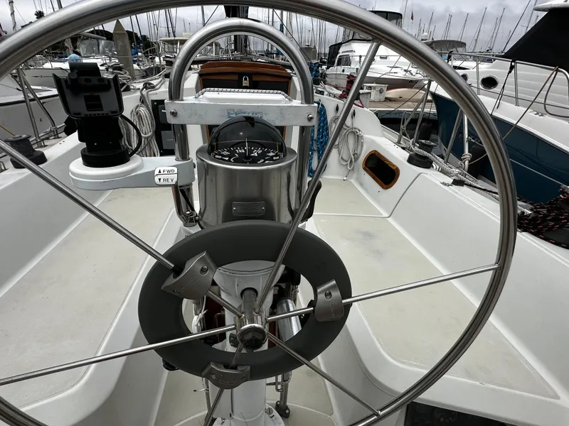 Slide: The Image of Steering wheel and cockpit of 1987 Ericson 34 2 sailboat in marina. - 32