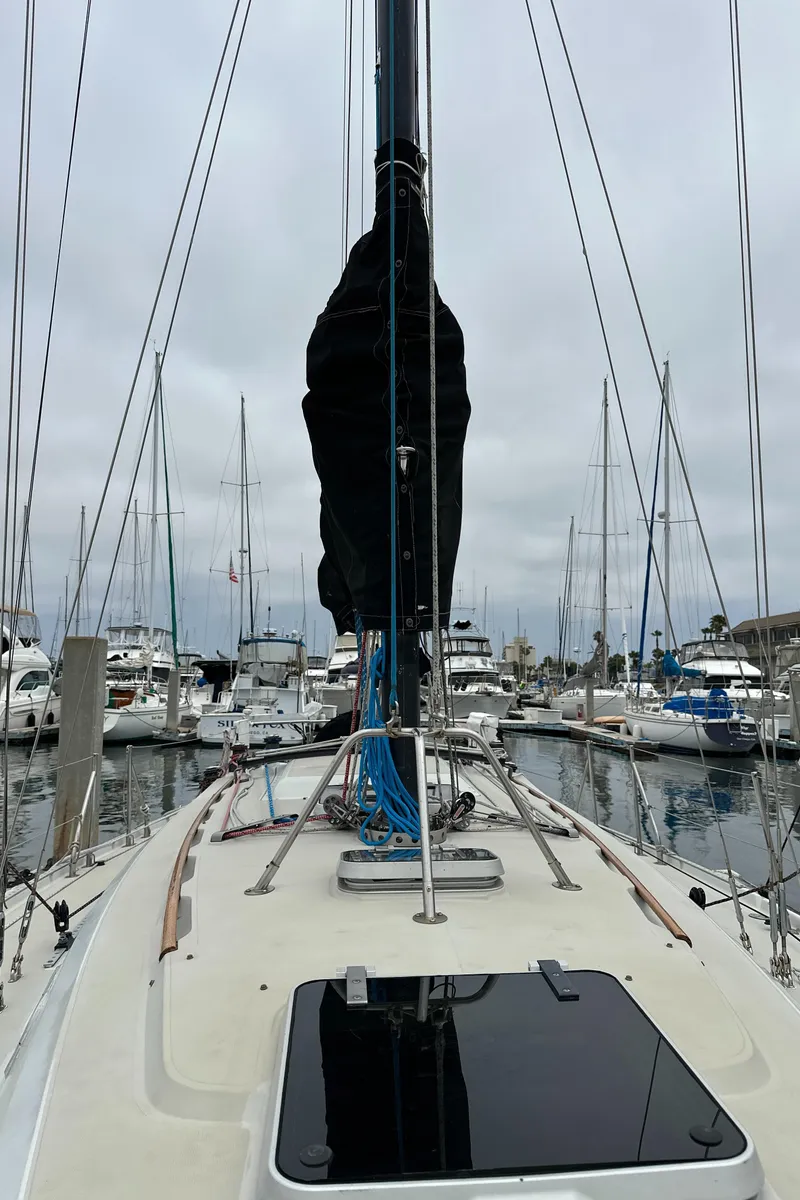 Slide: The Image of 1987 Ericson 34 2 sailboat docked in a marina, surrounded by other boats. - 35