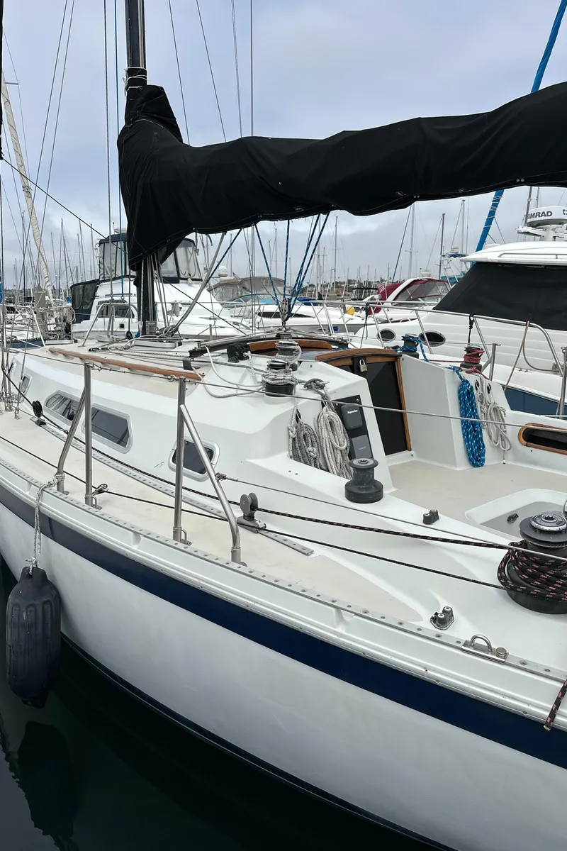 Slide: The Image of 1987 Ericson 34 2 sailboat docked in marina, featuring sleek design and rigging. - 39