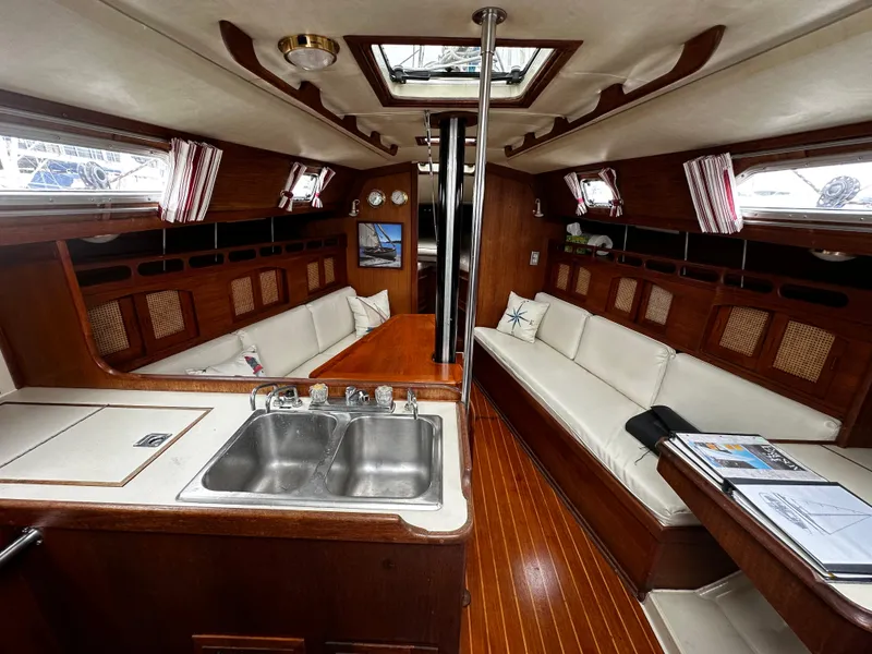 Slide: The Image of Interior of 1987 Ericson 34 2 sailboat with wood finish and white seating. - 4