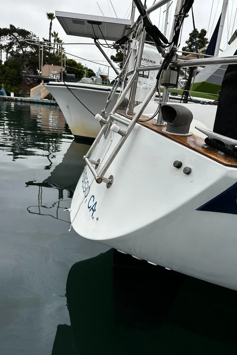 Slide: The Image of 1987 Ericson 34 2 sailboat docked in calm marina waters. - 41