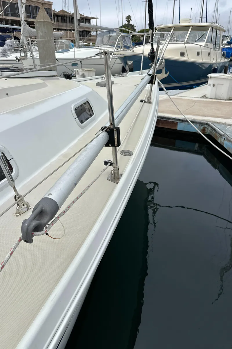 Slide: The Image of 1987 Ericson 34 2 sailboat docked at marina, side view of deck and railing. - 42