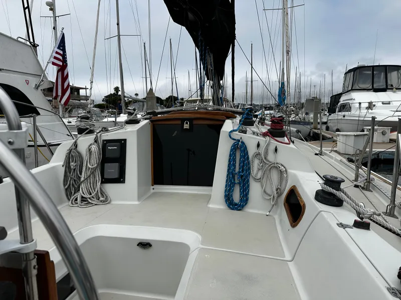 Slide: The Image of 1987 Ericson 34 2 sailboat deck with ropes and American flag in marina. - 47