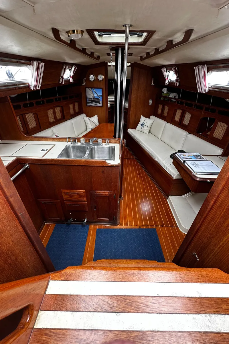 Slide: The Image of Interior of 1987 Ericson 34 2 sailboat with wood finish and white seating. - 5