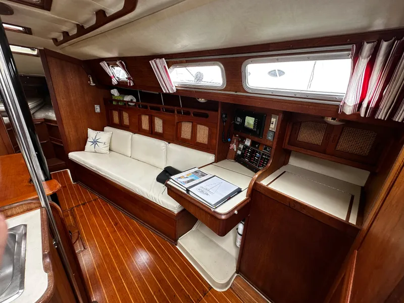 Slide: The Image of Interior of 1987 Ericson 34 2 sailboat with wood finish and white seating. - 6