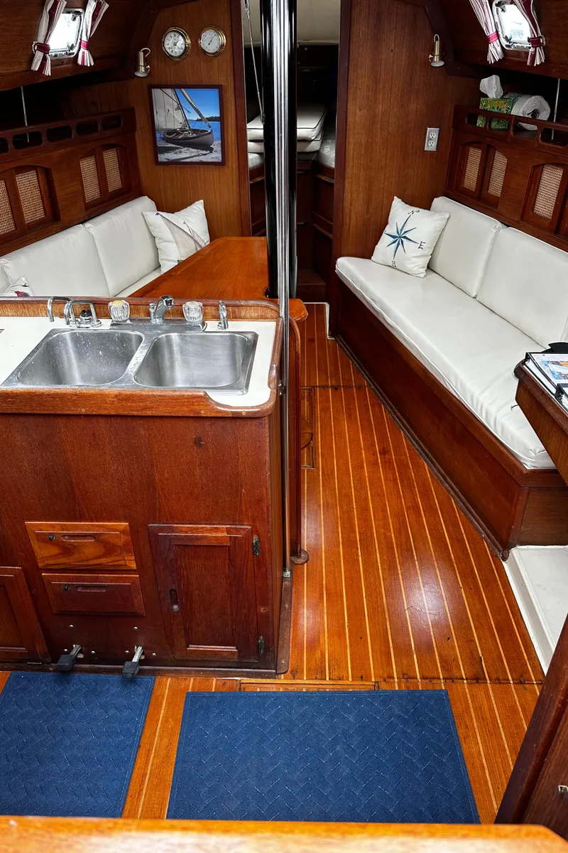 Slide: The Image of Interior of 1987 Ericson 34 2 sailboat with wooden finish and white seating. - 7