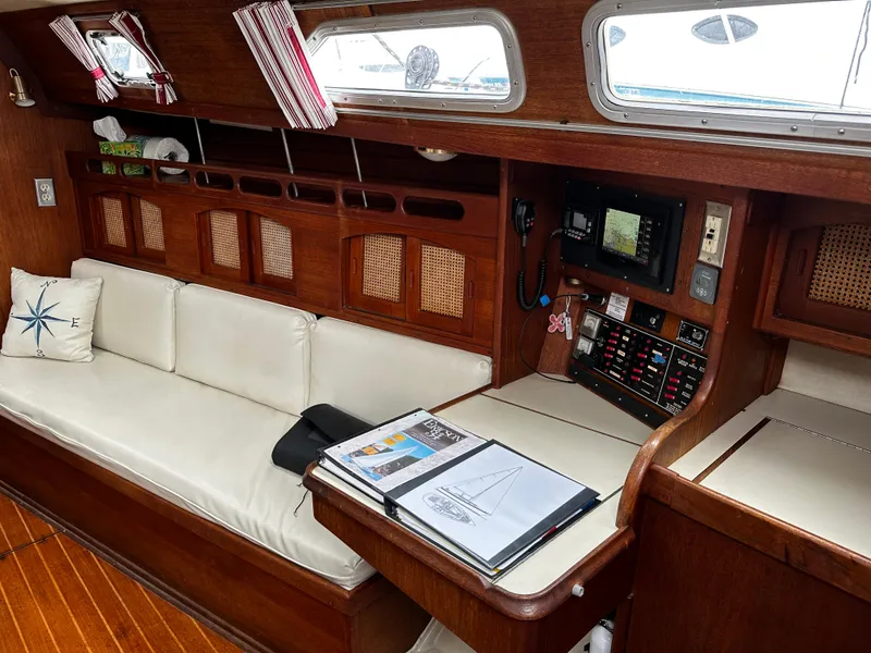 Slide: The Image of Interior of 1987 Ericson 34 2 sailboat with white seating and navigation equipment. - 8