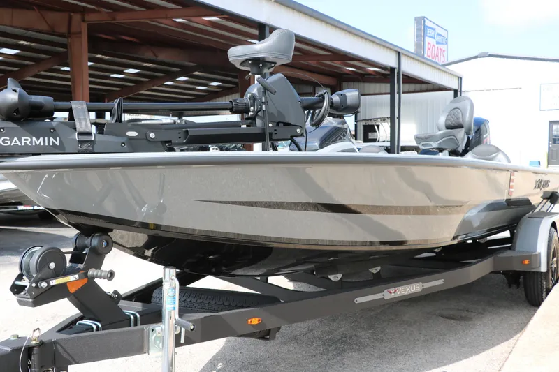 Slide: The Image of 2025 Vexus AVX1980 boat on trailer, equipped with Garmin technology, parked outdoors. - 6