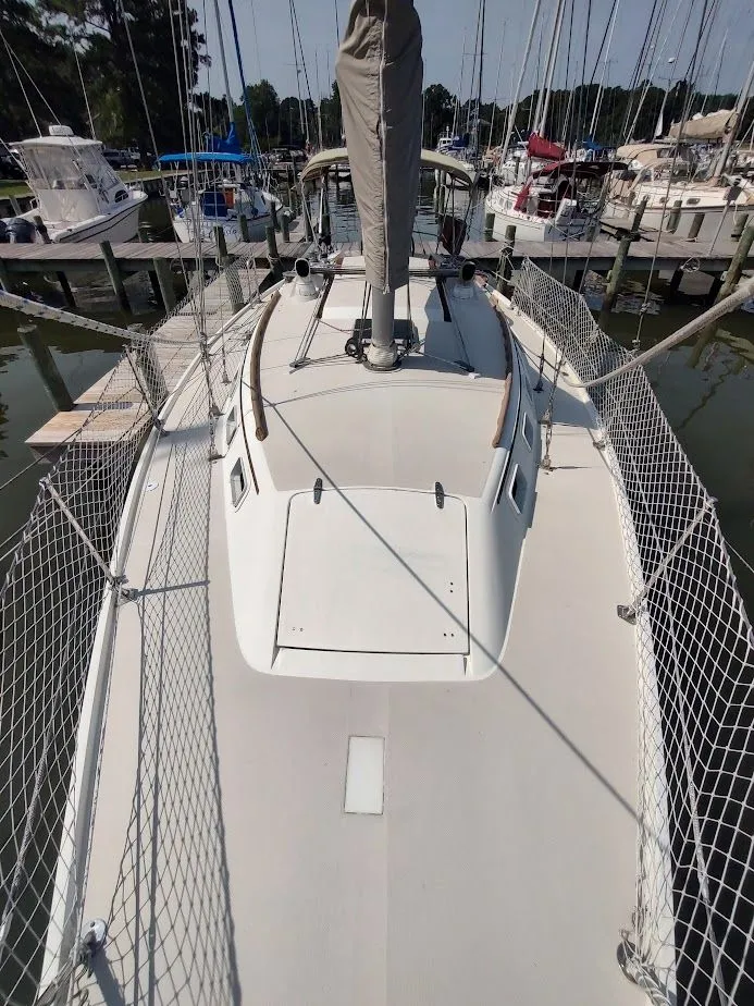 Slide: The Image of 1986 Catalina C-34 sailboat docked at marina, view of deck and mast. - 10