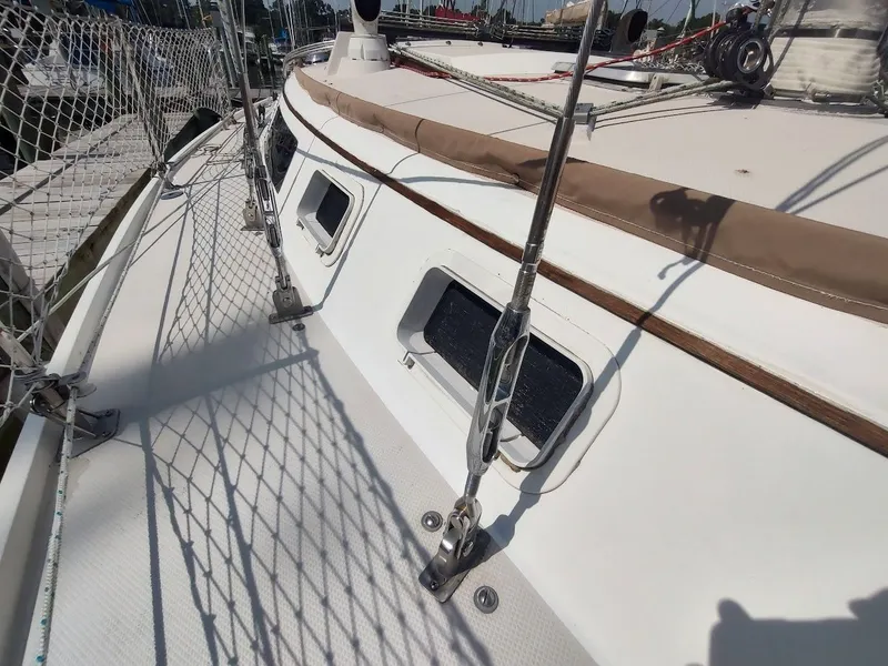 Slide: The Image of 1986 Catalina C-34 sailboat deck with rigging and netting, docked at marina. - 12