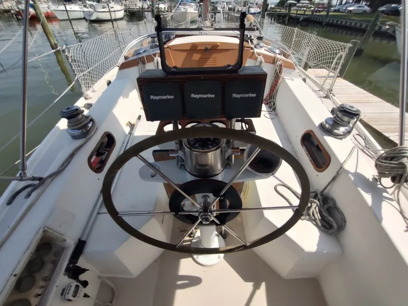 Slide: The Image of Cockpit of 1986 Catalina C-34 sailboat with steering wheel and navigation equipment. - 17