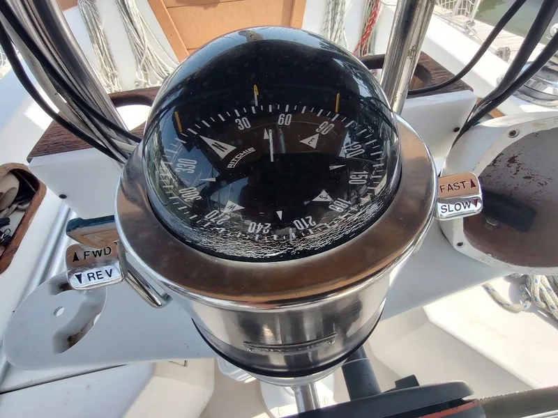 Slide: The Image of Compass and controls on a 1986 Catalina C-34 sailboat cockpit. - 19