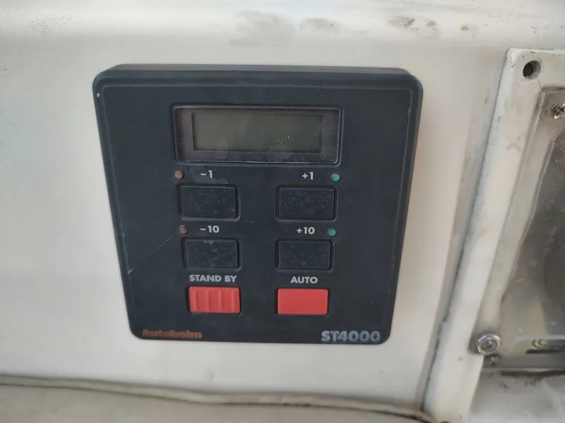 Slide: The Image of Autopilot control panel on 1986 Catalina C-34 sailboat, featuring buttons and display. - 21