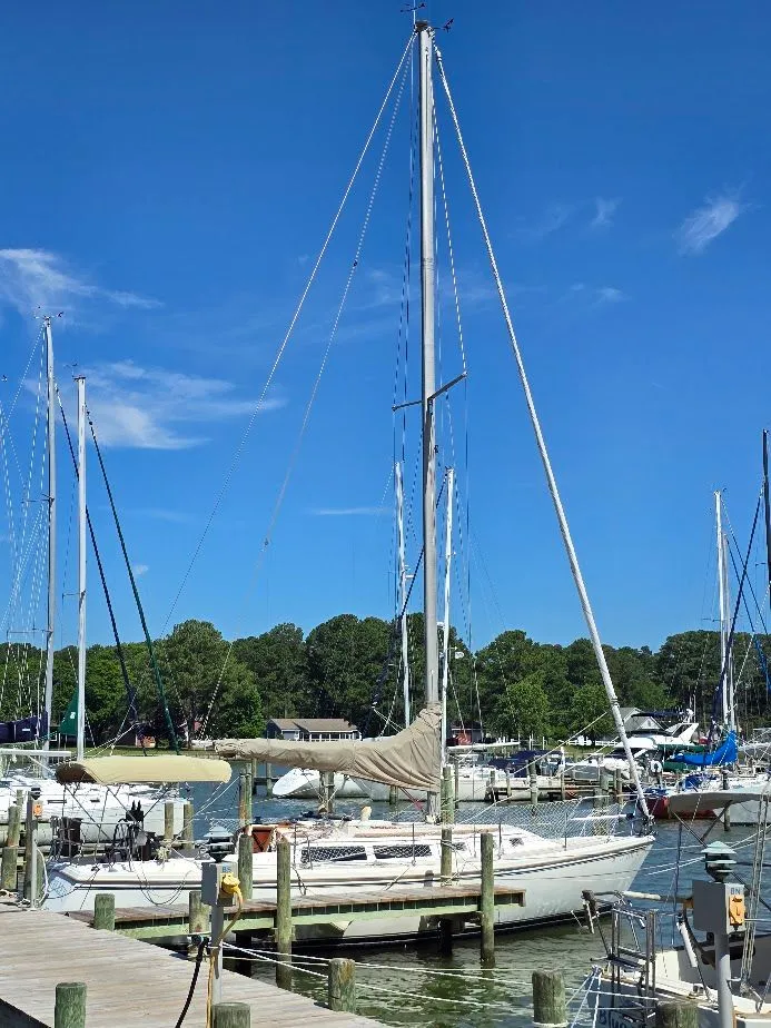 Slide: The Image of 1986 Catalina C-34 sailboat docked at a marina under a clear blue sky. - 3