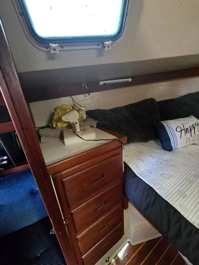 Slide: The Image of Interior of 1986 Catalina C-34 sailboat with wooden drawers and cozy bedding. - 30