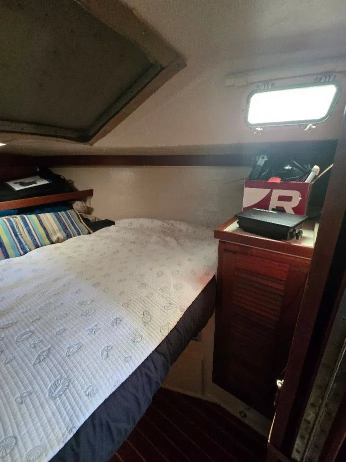 Slide: The Image of Cozy cabin interior of 1986 Catalina C-34 sailboat with bed and storage. - 31