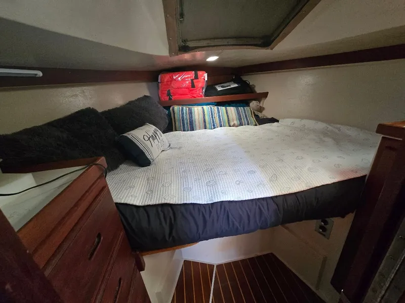 Slide: The Image of Cozy cabin interior of 1986 Catalina C-34 sailboat with bed and storage. - 32