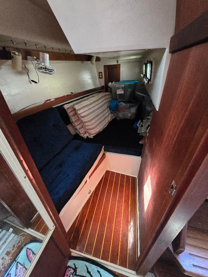 Slide: The Image of Interior cabin of a 1986 Catalina C-34 sailboat with seating and storage. - 36
