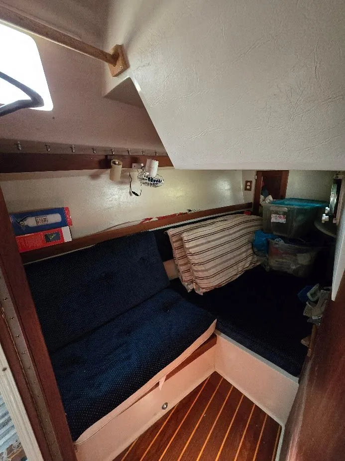 Slide: The Image of Cozy interior of 1986 Catalina C-34 sailboat with cushions and storage. - 37