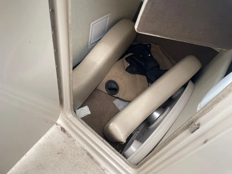 Slide: The Image of Interior of a 2003 Larson 214 boat showing seating and storage area. - 7