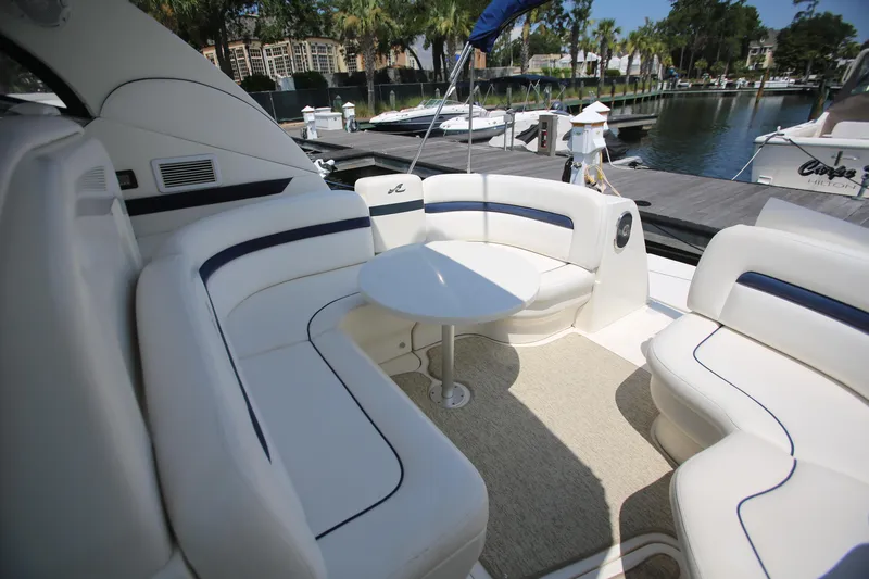 Slide: The Image of 2010 Sea Ray 390 Sundancer yacht interior with white seating and round table. - 16